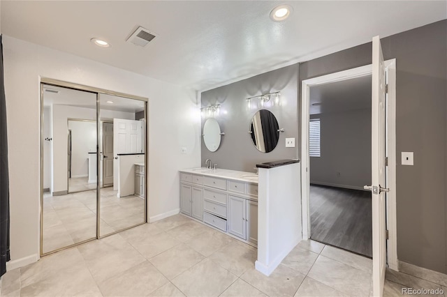 bathroom featuring tile patterned floors and vanity