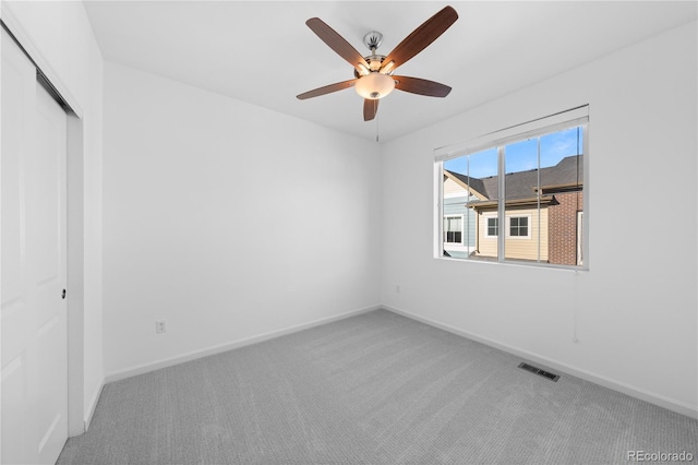 unfurnished bedroom with a closet, carpet flooring, and ceiling fan