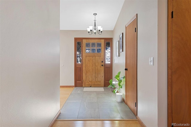 foyer with light hardwood / wood-style floors and an inviting chandelier