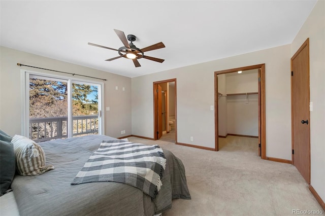 bedroom with access to exterior, ceiling fan, light colored carpet, a walk in closet, and a closet