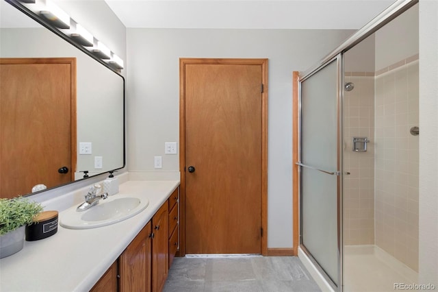 bathroom with a shower with door and vanity