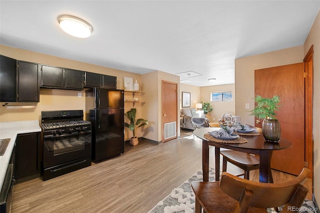 kitchen featuring black appliances and light hardwood / wood-style flooring