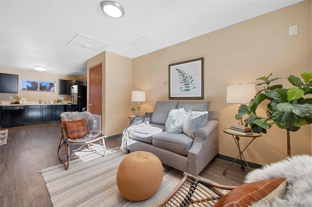 living room with hardwood / wood-style flooring and sink