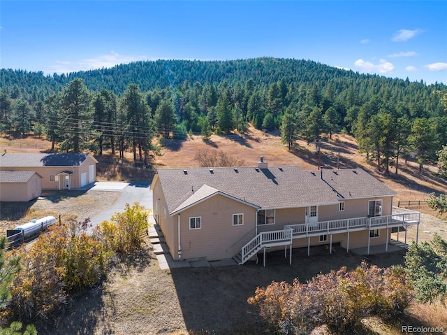 birds eye view of property featuring a view of trees