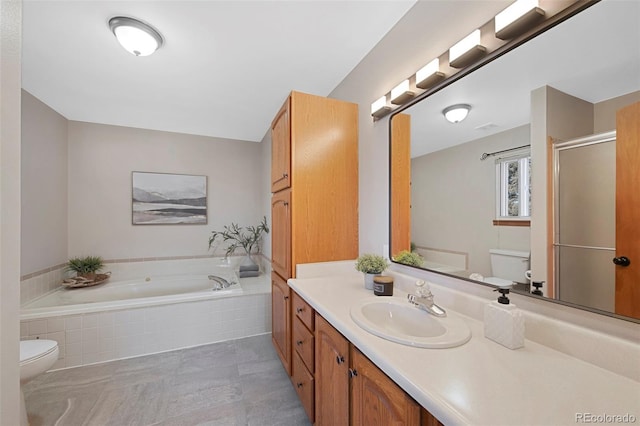 full bathroom with a stall shower, vanity, toilet, and a bath