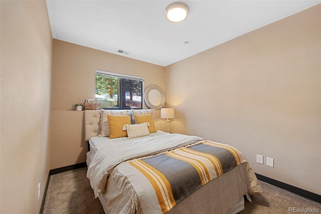 carpeted bedroom with visible vents and baseboards