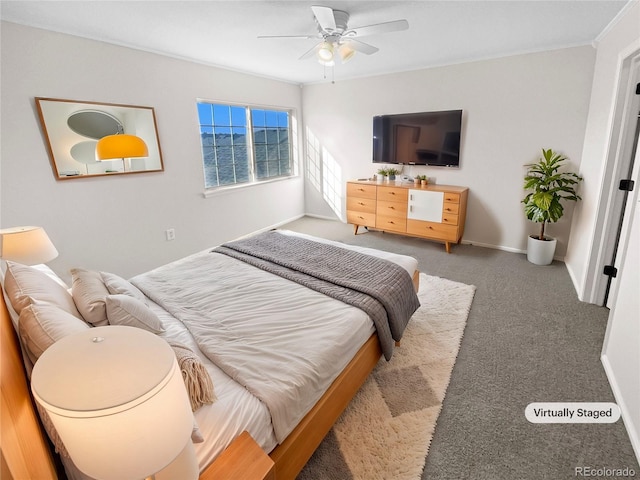 carpeted bedroom with ceiling fan and ornamental molding