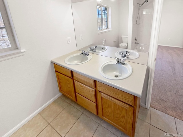 bathroom featuring tile patterned floors, vanity, and toilet