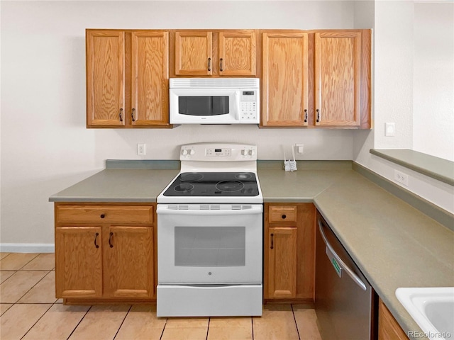 kitchen with light tile patterned floors and white appliances