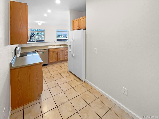 kitchen with dishwasher, sink, light tile patterned floors, white fridge with ice dispenser, and range