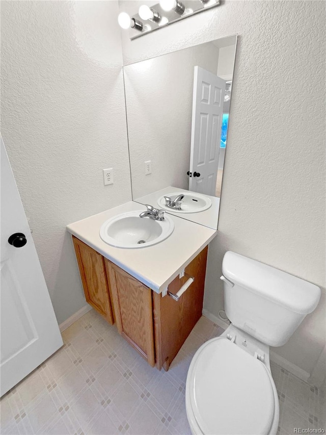 bathroom with toilet and vanity