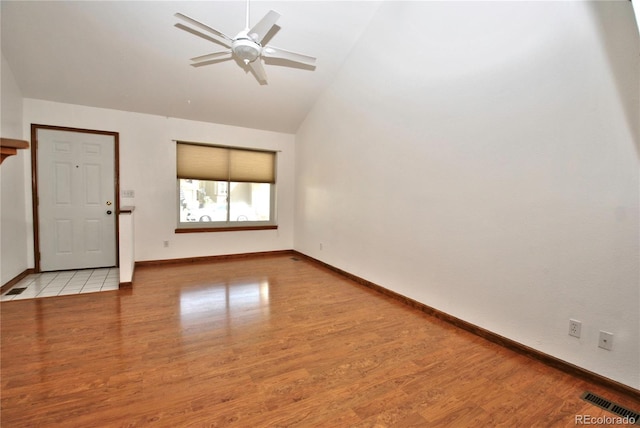 interior space with baseboards, visible vents, and wood finished floors