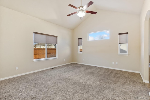 empty room with high vaulted ceiling, ceiling fan, and carpet flooring