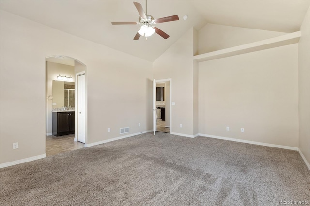 empty room featuring ceiling fan, light colored carpet, and high vaulted ceiling