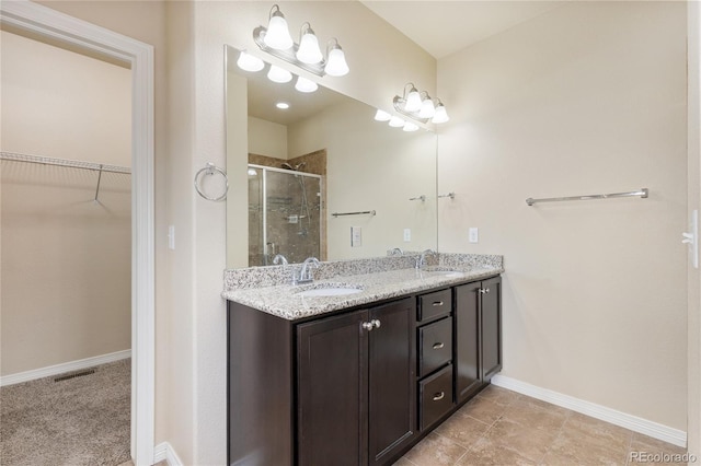 bathroom with vanity and a shower with shower door