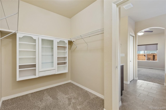 walk in closet with carpet flooring