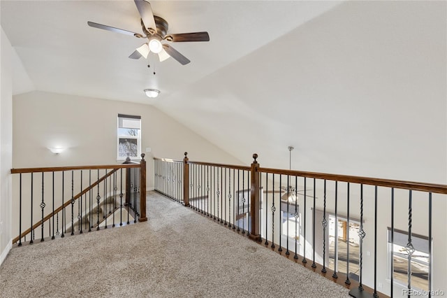 hall with vaulted ceiling and carpet flooring