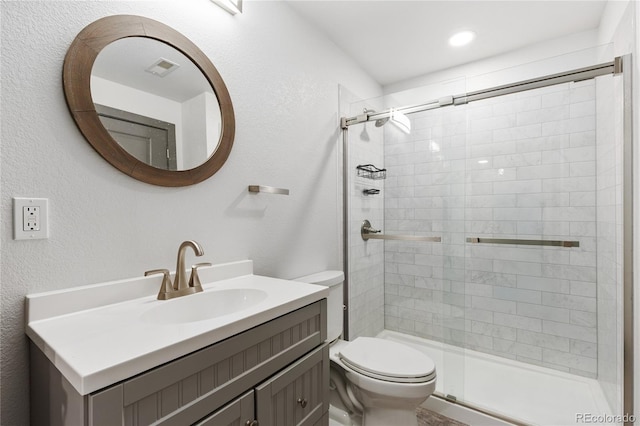 bathroom featuring vanity, toilet, and an enclosed shower