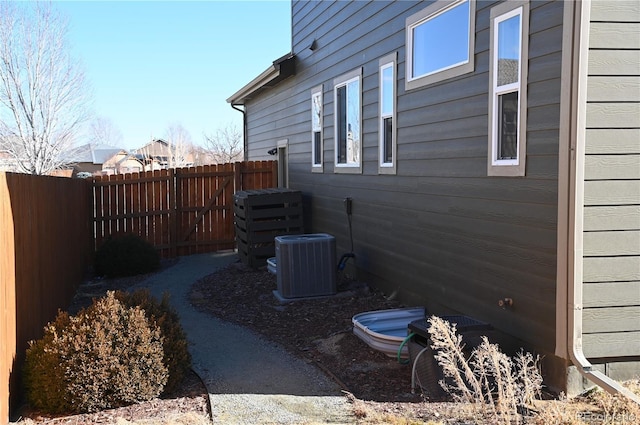 view of side of home with central AC unit