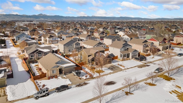 snowy aerial view featuring a mountain view