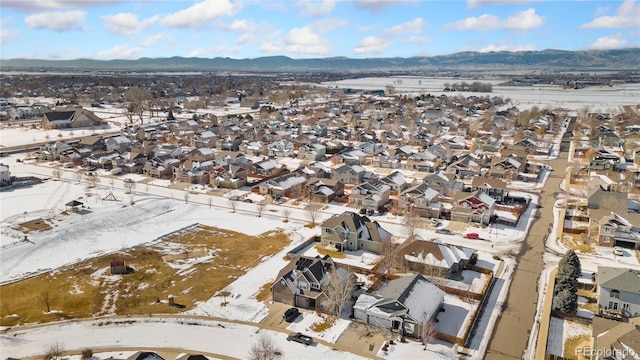 snowy aerial view featuring a mountain view