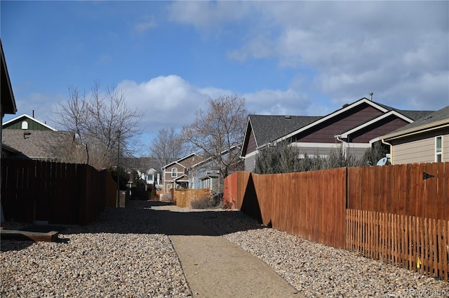 view of side of property with fence and a residential view