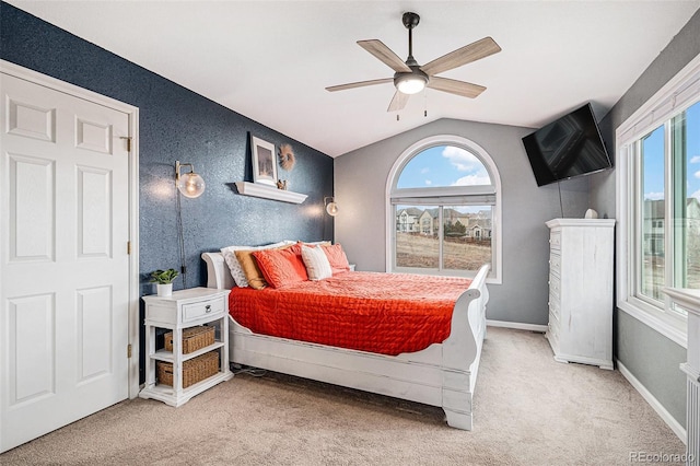 carpeted bedroom with lofted ceiling, ceiling fan, and baseboards