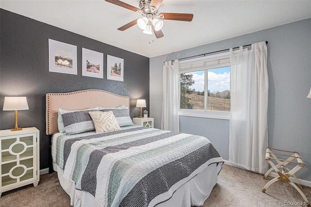 carpeted bedroom featuring ceiling fan and baseboards