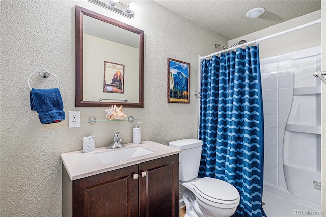 bathroom featuring a textured wall, a shower with shower curtain, toilet, vanity, and a textured ceiling