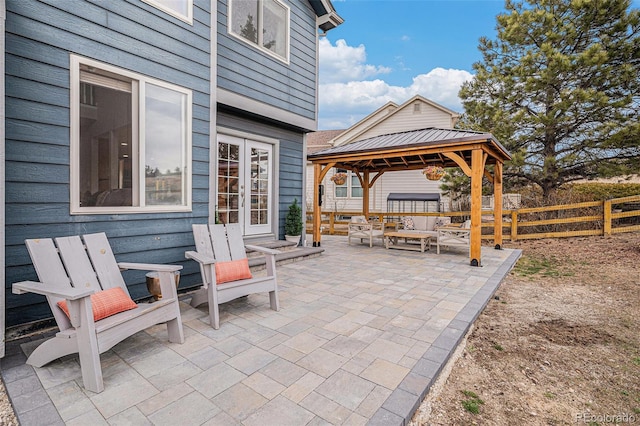 view of patio / terrace with a gazebo, french doors, and fence