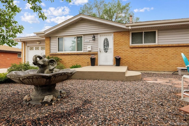 8460 Corona St, Denver, CO 80229 - ranch-style home with brick siding and a garage