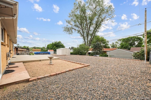 8460 Corona St, Denver, CO 80229 - view of yard featuring a shed and a patio