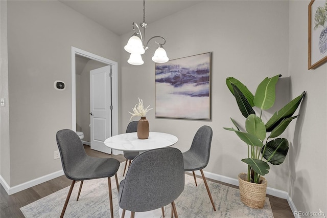 dining room with wood-type flooring and a chandelier