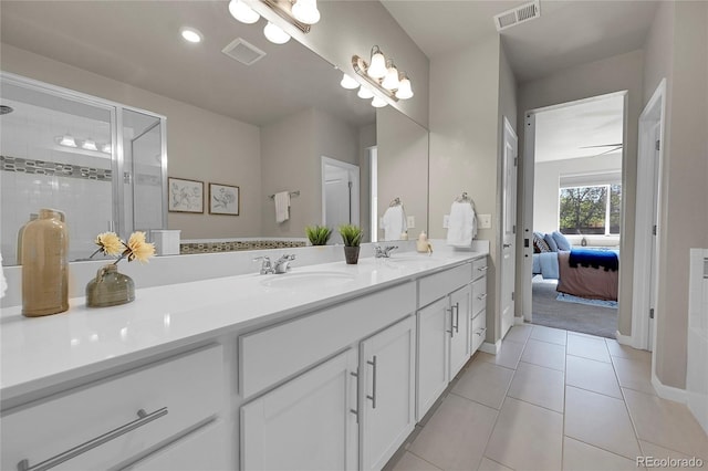 bathroom featuring vanity, a shower with door, and tile patterned flooring