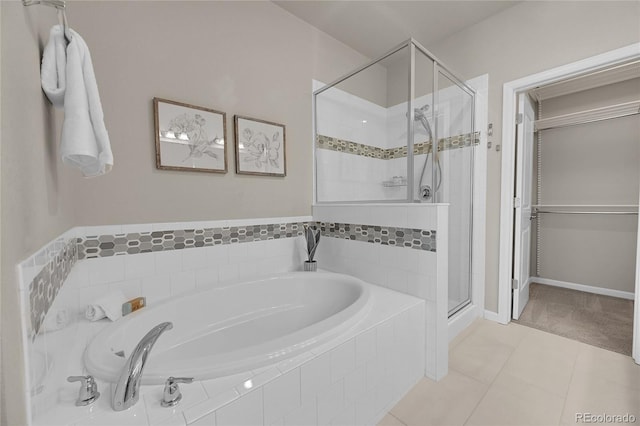 full bath with baseboards, tile patterned flooring, a shower stall, and a garden tub
