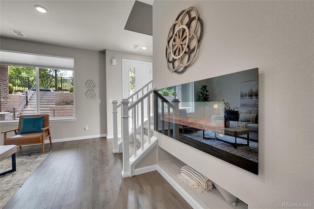 stairs featuring wood-type flooring, recessed lighting, baseboards, and a wealth of natural light