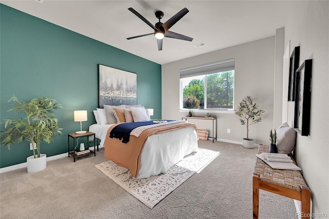bedroom featuring visible vents, baseboards, a ceiling fan, and carpet floors