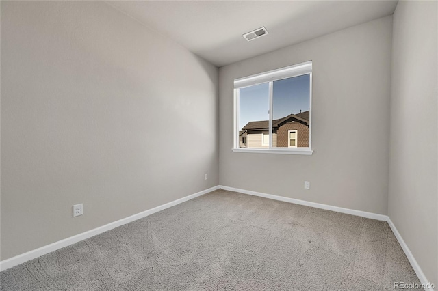 carpeted spare room with baseboards and visible vents