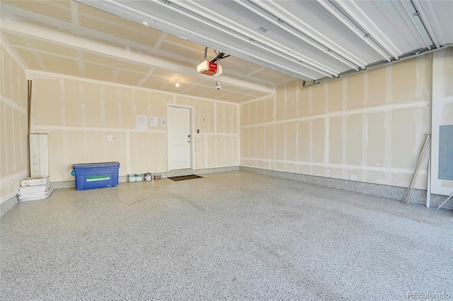 garage with a garage door opener and electric panel