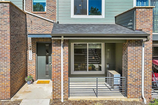 property entrance featuring brick siding