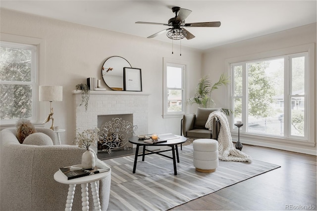 3055 Clermont St, Denver, CO 80207 - living area featuring healthy amount of natural light, wood finished floors, a fireplace, and a ceiling fan