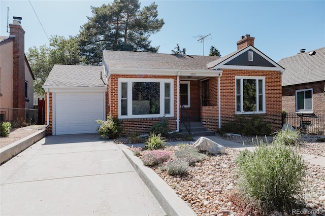 3055 Clermont St, Denver, CO 80207 - view of front of house featuring brick siding, a garage, fence, and concrete driveway