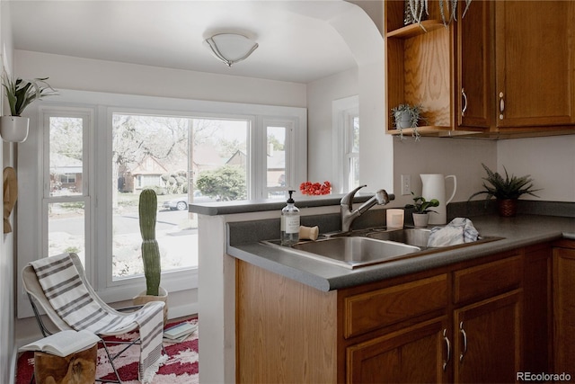 3055 Clermont St, Denver, CO 80207 - kitchen with a sink, healthy amount of natural light, and brown cabinets