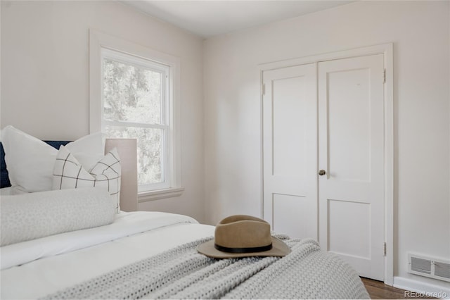 3055 Clermont St, Denver, CO 80207 - bedroom with multiple windows, a closet, and wood finished floors