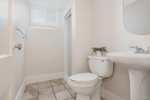 3055 Clermont St, Denver, CO 80207 - bathroom featuring toilet, a shower, a sink, and baseboards