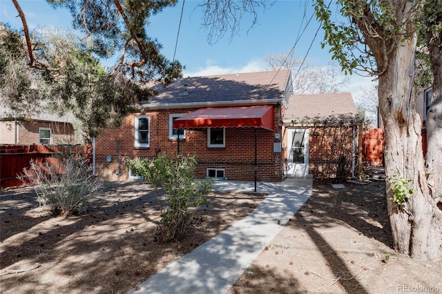 3055 Clermont St, Denver, CO 80207 - view of front of property with fence, brick siding, and a shingled roof