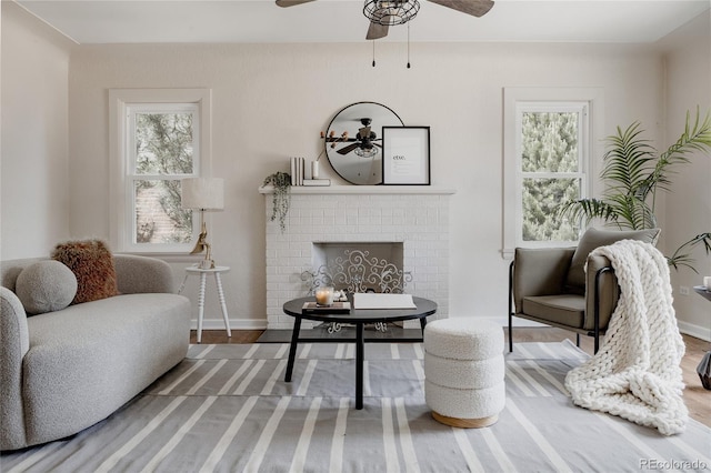 3055 Clermont St, Denver, CO 80207 - sitting room with a ceiling fan, healthy amount of natural light, a fireplace, and wood finished floors