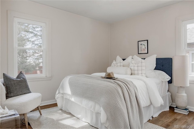 3055 Clermont St, Denver, CO 80207 - bedroom with multiple windows, wood finished floors, and baseboards