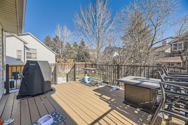 wooden terrace with an outdoor fire pit