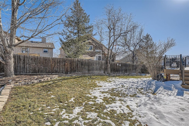 snowy yard featuring a wooden deck